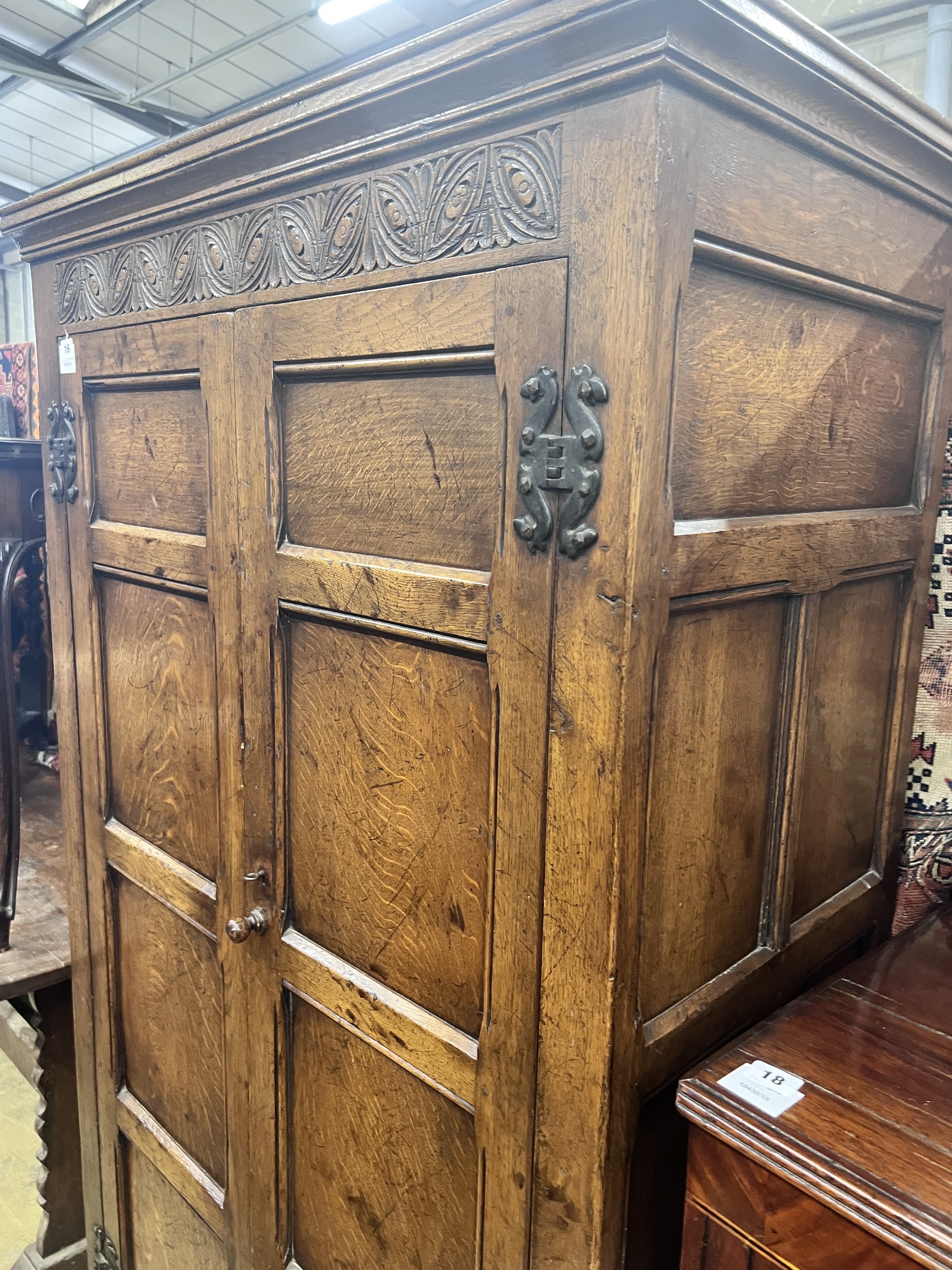 An 18th century style panelled oak hanging cupboard, width 96cm, depth 53cm, height 178cm